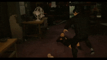 a man in a suit is kicking another man 's head
