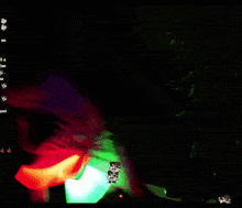 a person is playing with glowing sticks in a dark room with a screen that says ' a ' on it