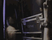 a poster for chase atlantic shows a man standing in front of a briefcase