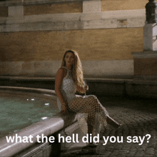 a woman in a white dress sits next to a fountain with the words " what the hell did you say " below her
