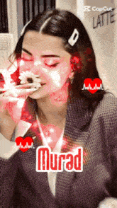 a woman is eating a cake and the name murad is on the bottom right