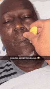 a man is laying in a hospital bed with a lemon in his mouth and a caption that says grandpa awoke like dracula
