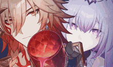 a man and a woman are holding a red glass