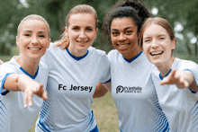 a group of women wearing white shirts that say fc jersey on them