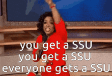 a woman in a red dress is holding a microphone and saying you get a ssu you get a ssu