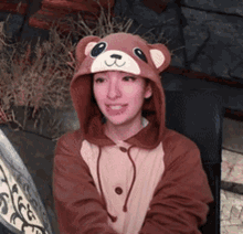 a woman wearing a teddy bear hooded jacket