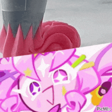 a close up of a pink cartoon character next to a close up of a pink flower .