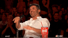 a man in front of a crowd with a sonic cup