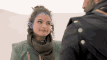 a man and a woman are looking at each other and the woman has purple ears
