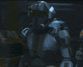 a robot with a helmet on is standing in a dark room talking on a cell phone .
