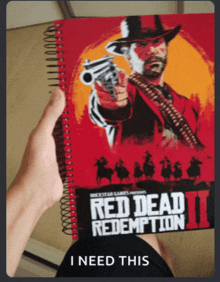 a person is holding a red dead redemption 2 book