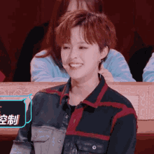 a woman is smiling in front of a sign that says ' chinese '