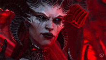 a close up of a demon with a red background
