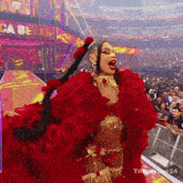 a woman in a red and gold outfit stands in front of a sign that says ca be on it