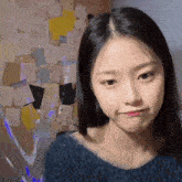 a woman making a funny face in front of a wall full of sticky notes