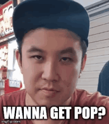 a man wearing a hat is making a funny face with the caption wanna get pop ?