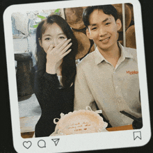 a photo of a man and a woman with a cake that says " i anh chua "