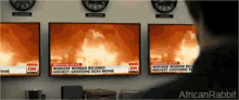 a man is looking at a cnn news report on a wall
