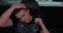 a man sits in a chair that says spawn on the back