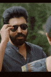 a man with a beard is wearing sunglasses and a shirt that says asmp4