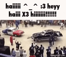 a group of people are watching a car race .