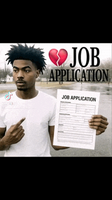 a man holding a job application with a broken heart on it