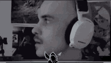 a man wearing a pair of white headphones with the word steelseries on them .