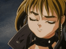 a close up of a girl 's face with her eyes closed and the letter l on her earring