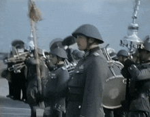 a man in a helmet stands in front of a group of men