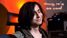 a man with long hair is smiling with the words omg it 's so cool below him