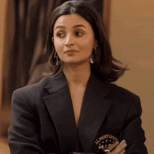 a woman wearing a black jacket with a patch that says almost good on it