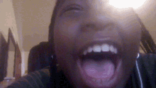 a close up of a person 's face with their mouth open
