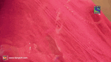 a woman in a pink veil is on a sony television hd screen