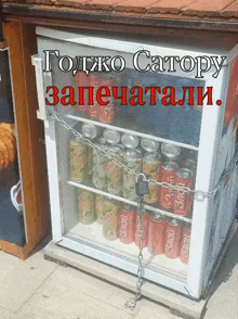 a fridge filled with soda cans is chained up and says " годжо сатору запечатали "