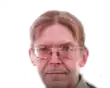 a man wearing glasses is looking at the camera on a white background .