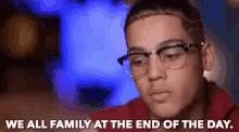 a man wearing glasses says we all family at the end of the day