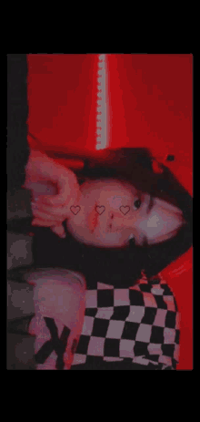 a close up of a woman 's face with hearts on it