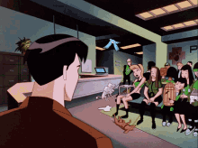a group of people sitting in a room with a sign that says p on it