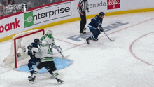 a hockey game being played in front of a banner that says enterprise