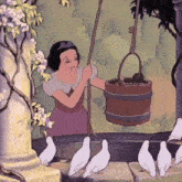 snow white from snow white and the seven dwarfs is holding a wooden bucket
