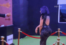 a man in a suit shakes a woman 's hand in front of a sign that says pdtv6