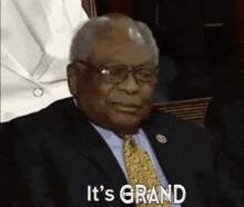 an older man in a suit and tie is saying it 's grand .