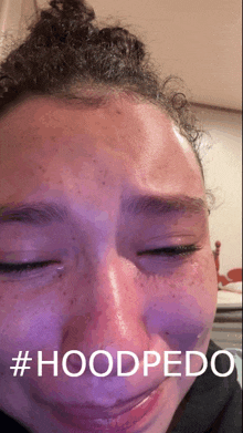 a close up of a woman 's face with #hoodpedo written on the bottom