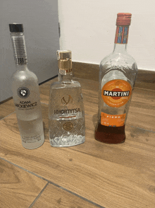 three bottles of alcohol one of which is a martini