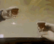 a man and a woman are sitting at a table holding wine glasses .