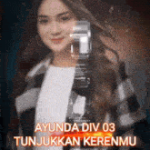 a woman is holding a watch with the words ayunda div 03 tunjukkan kerenmu on the bottom .