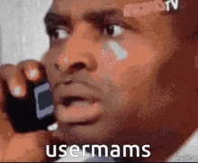 a man is talking on a cell phone and the words usermams are on the bottom of the image .