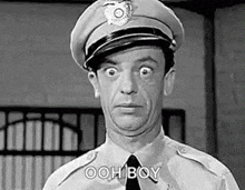 a black and white photo of a police officer making a funny face and saying ooh boy .