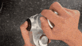 a close up of a person 's hand holding a metal object