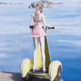 a girl in a pink bikini is riding a segway on the beach .